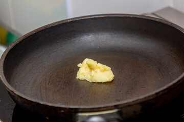 Butter is heated in a hot frying pan for cooking
