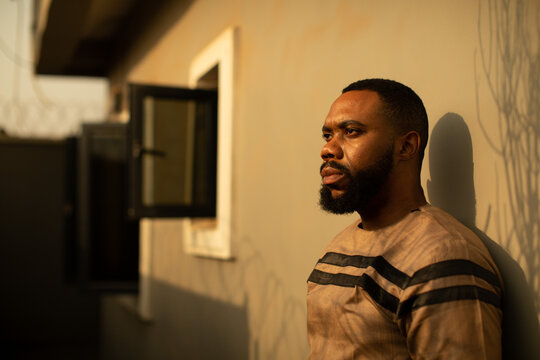 Wide angle shot of a black african environmentalist pondering 