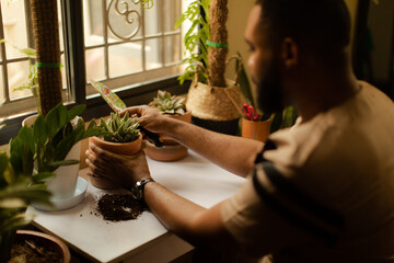 Portrait of a black male doing self care at home with plants 