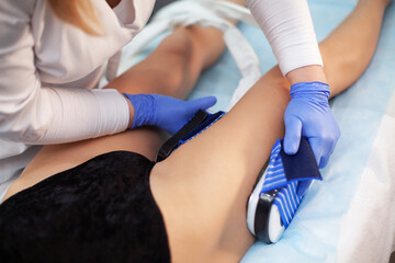 Woman at electro stimulation therapy in beauty center