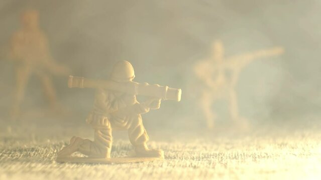 A beige toy soldier is sitting with a grenade launcher. The smoke envelops him