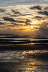 Fantastic view of the dark overcast sky. Dramatic and picturesque golden evening sunset scene over the sea. Storm clouds, storm passing over sea, dramatic clouds after storm at sunset. Defocused. High