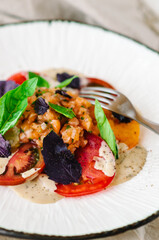 Mix tomatoes with capers and tuna. Tomato menu in a restaurant.
