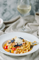 pasta with chicken, bacon, cherry tomatoes and zucchini with light cream tomato sauce