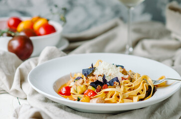Pasta with chicken, bacon, cherry tomatoes and zucchini with light cream tomato sauce