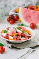 Fresh salad with water-melon, tomatoes, feta cheese and mint.