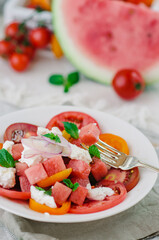 Fresh salad with water-melon, tomatoes, feta cheese and mint.