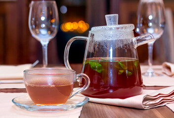 Glass teapot with tea brewed with herbs and berries