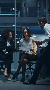 Vertical Clip: Diverse Team of Managers Working in Big City Office in the Evening. Colleagues Talk, Discuss Business Opportunities, Evaluate Financial Reports, Plan Investment Strategy.