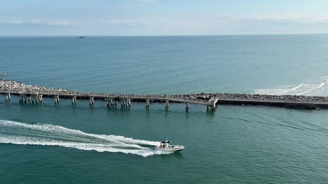 A fishing boat going by a cruise ship out of Port Canaveral, FL.