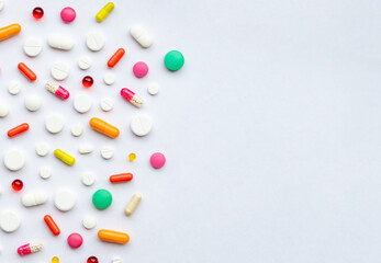 Many different pills on white background, flat lay.Global Pharmaceutical Industry and Medicinal Products - Colorful Pills, Tablets and Capsules, medicine and drug concept.copy space