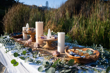 Beautifully decorated ceremonial table with mineral stones, smudging sticks, and candles