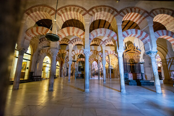 Fototapeta premium Medieval moorish architecture, colorful achways with columns in old mosque in Cordoba with no people, Andalusia, Spain