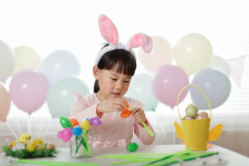 young girl making easter craft at home