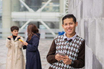 Selective focus shot of a Hispanic man with his coworkers in the foreground