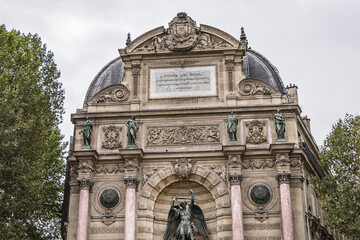 Fototapeta na wymiar Fragment of a baroque fountain Saint-Michel (1858 - 1860). Fountain Saint-Michel - popular architectural historical landmark. Latin Quarter, Paris, France.