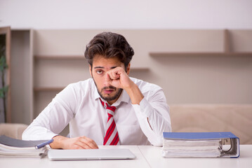 Fototapeta premium Young male employee working from home during pandemic