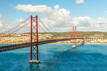 The 25 de Abril Bridge, 25th of April Bridge, a red suspension bridge over the Tagus river, Lisbon, Portugal