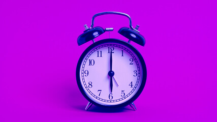 vintage old black alarm clock on pink background