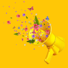 flowers in a megaphone. a bouquet of flowers sticks out of the megaphone. creative concept. Summer...