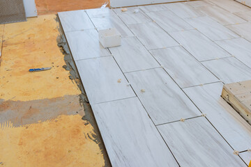 Applying tile adhesive to the floor process of laying ceramic tiles on glue smeared floors