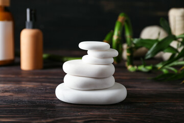 Fototapeta na wymiar Stack of white spa stones on wooden table