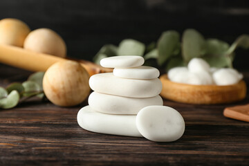 Fototapeta na wymiar Stack of white spa stones on wooden table