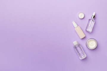 Natural facial cosmetic products on color background, top view