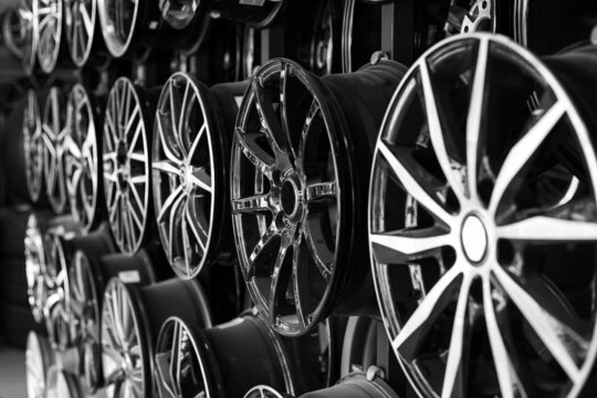 Rows of disks of various configurations in a shop window. Sale of disks and alloy wheels