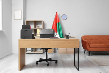 Interior of light office with modern workplace and UAE flag