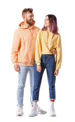 Cool young couple in hoodies on white background