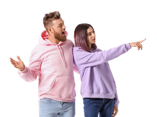 Cool young couple in hoodies on white background