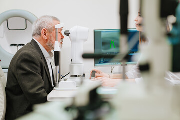 ophthalmologist examination of elderly man on corneo topographer.modern clinic