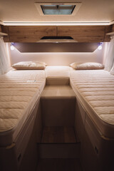 Fototapeta na wymiar Bed inside a new luxury camper van motorhome