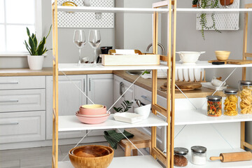 Modern shelving unit with dishware in kitchen