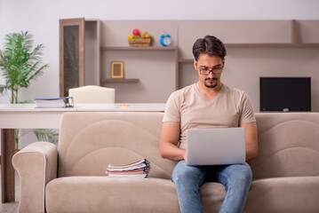 Young male employee working from house