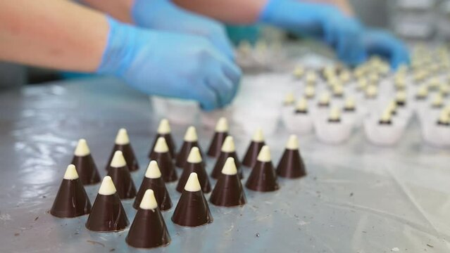 Professional confectioner prepairing sweet candies. Pastry making cake proccess.