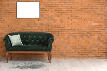 New green sofa near brick wall
