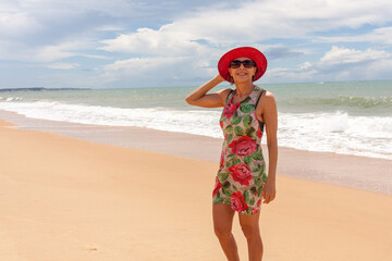 Lady at the beach on a windy day in Caraiva Bahia, Brazil