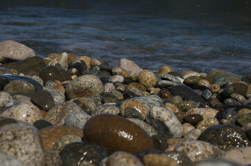 shores of a lake, lake shore with wet stones, bocha stone