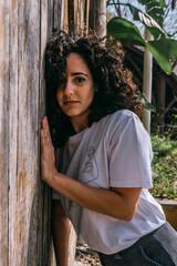 Young woman posing in front of a wood door