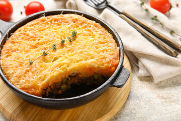 Frying pan with tasty Shepherd's pie on light background