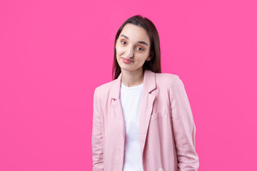 Fototapeta premium Portrait of beautiful young woman in pink jacket thinking isolated on red background