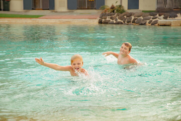 Kids swimming at the Settlement Cove Lagoon swimming pool in Redcliffe, QLD Australia