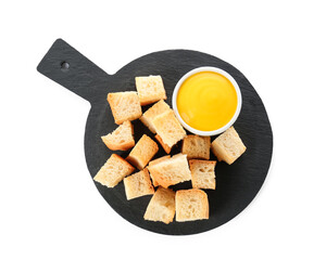 Board with crunchy croutons and sauce isolated on white, top view