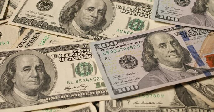 New and old 100 US Dollar banknotes rotating. Background and pattern of US Dollar currency