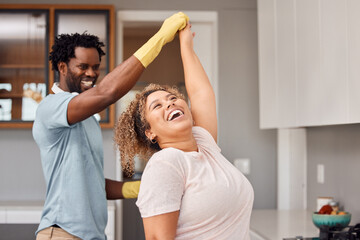 Its always a good time when we do chores together. Shot of a young couple dancing while cleaning at home.