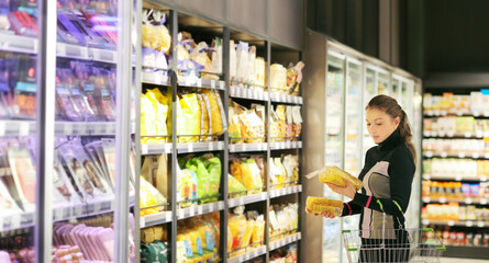 Woman choosing a dairy products at supermarket