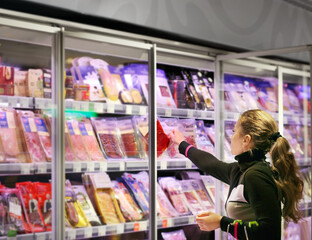 Woman choosing a dairy products at supermarket