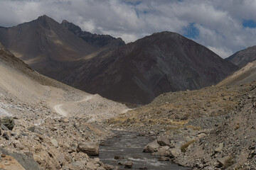 A gravel road leading through the Andes Mountain range en route to Valle de Colina, Chile, South America